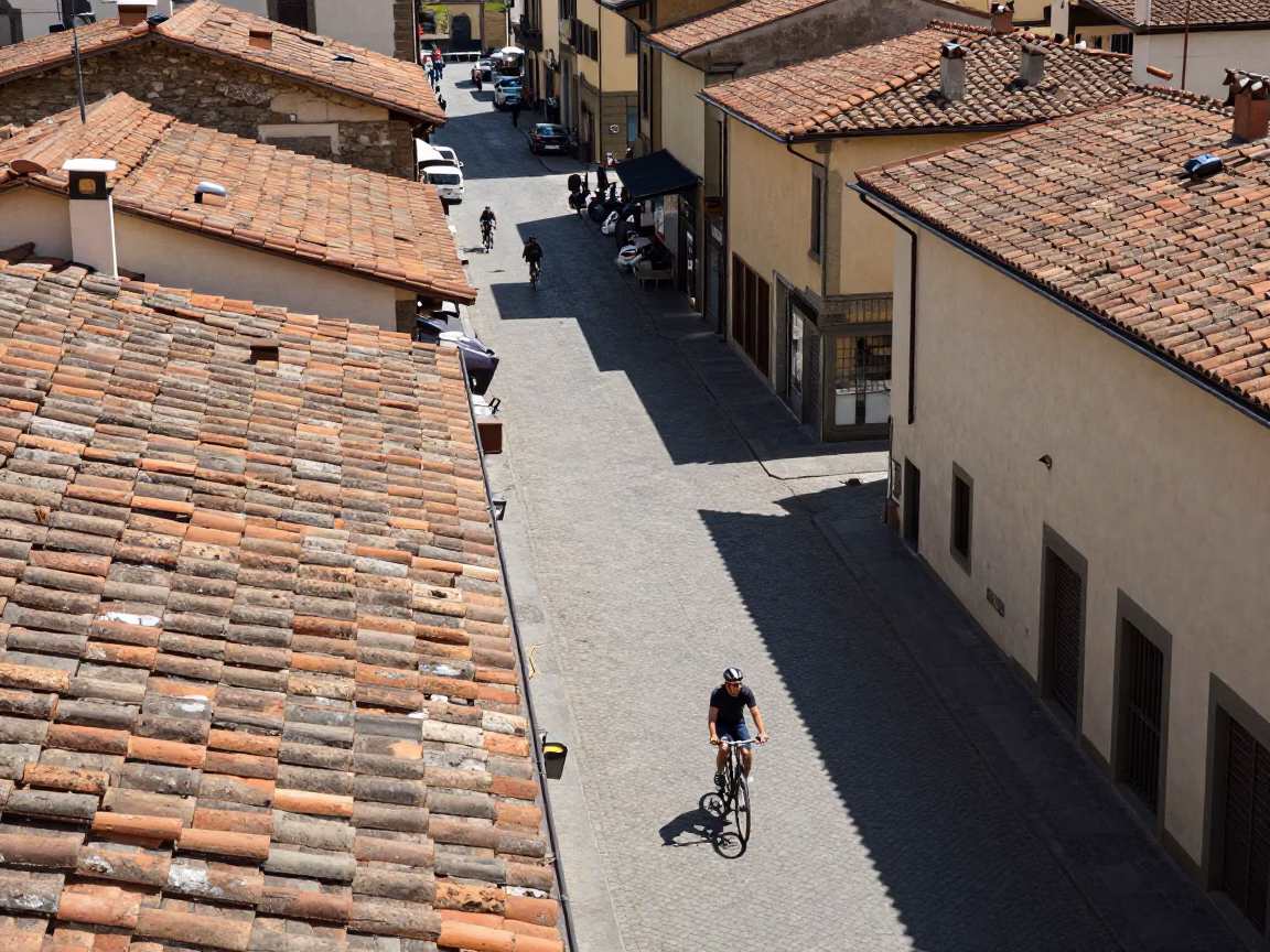 Busy Midday Florence Street Scene with Cyclist and Cobblestone Traffic in in Florence, Italy