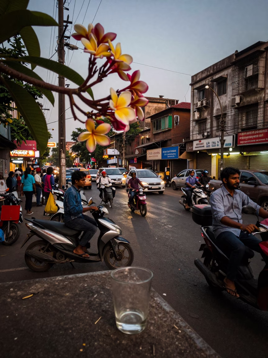 Busy Mumbai Street Corner Evening with Frangipani Branch and Glass Cup in in Mumbai, India