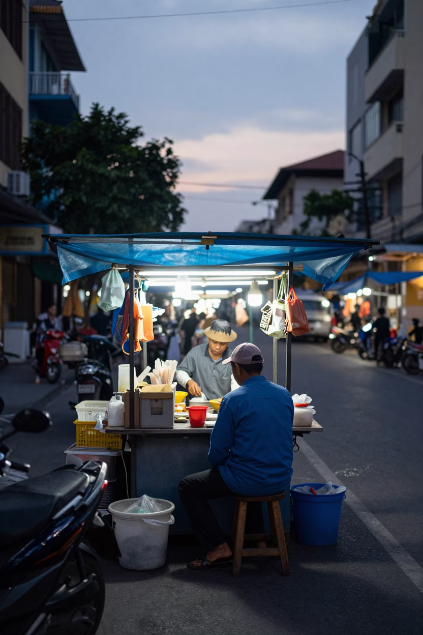 Busy Saigon Street Vendor Stall Before Dawn with Carrots and Work Stool in in Ho Chi Minh City, Vietnam