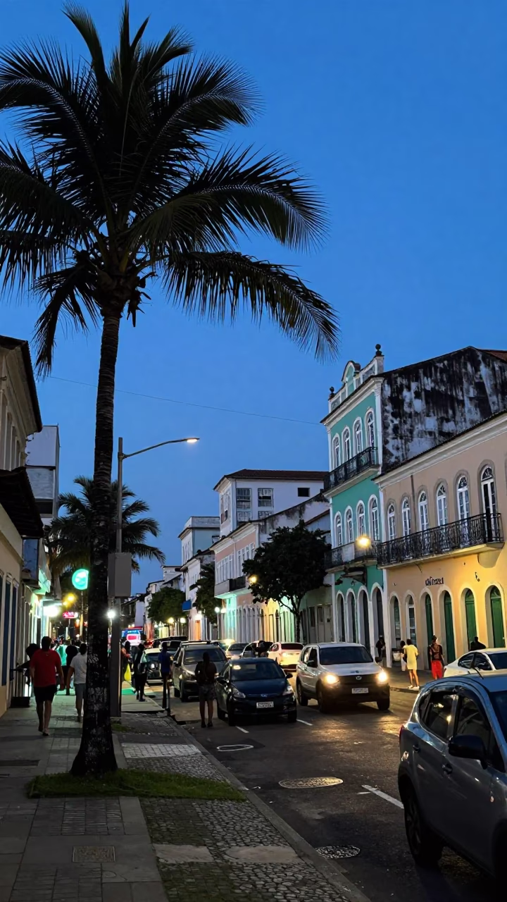 Busy Salvador Brazil Evening Street Scene with Palm Trees and Vintage Motorcycle in in Salvador, Brazil
