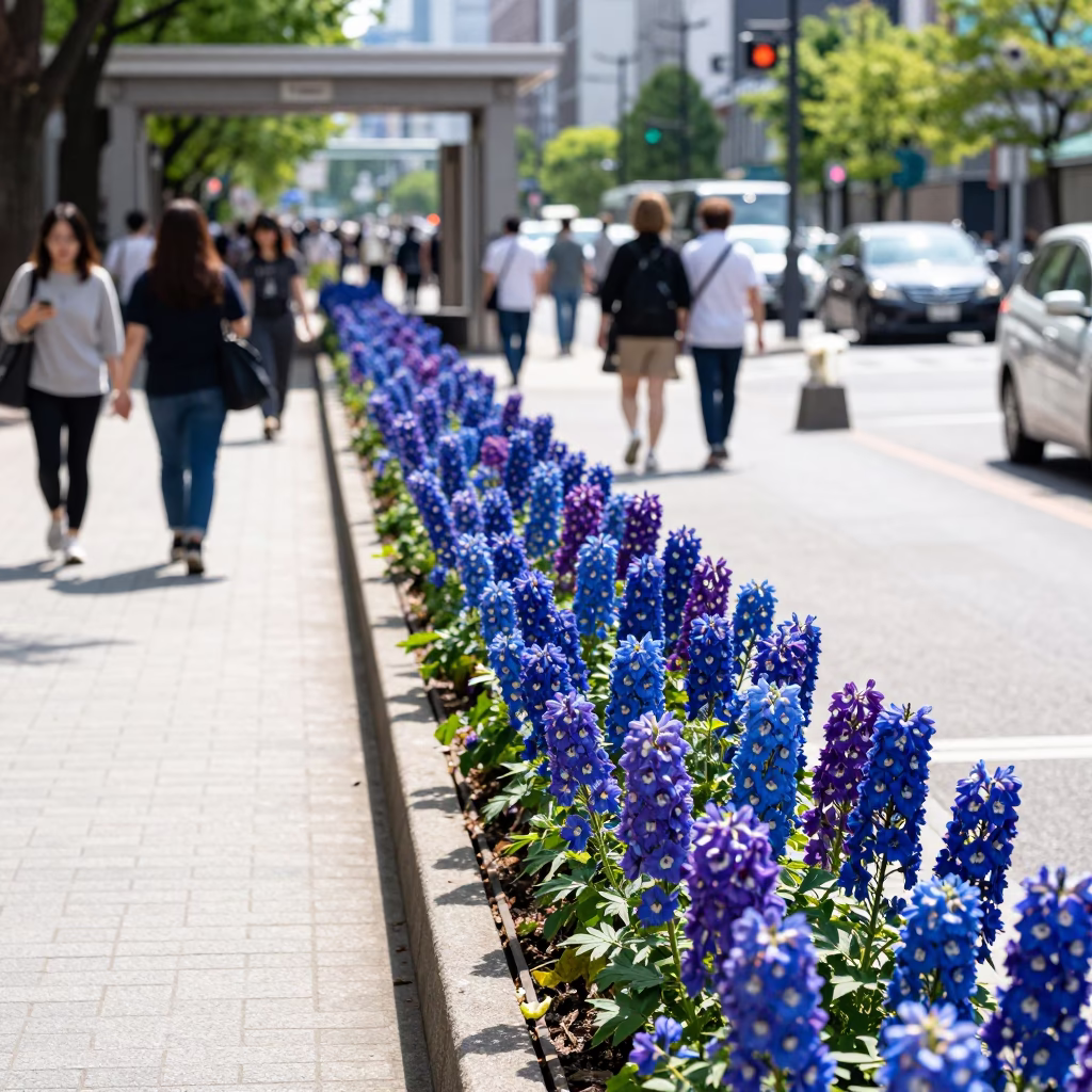 Busy Sapporo Street Scene at Midday with Delphinium Border and Local Pedestrians in in Sapporo, Japan