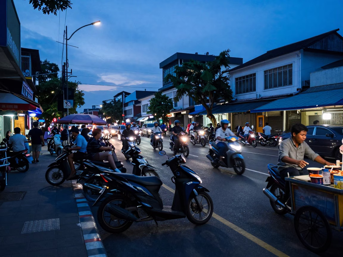 Busy Surabaya Street Scene at Indigo Twilight with Scooters and Local Life in in Surabaya, Indonesia