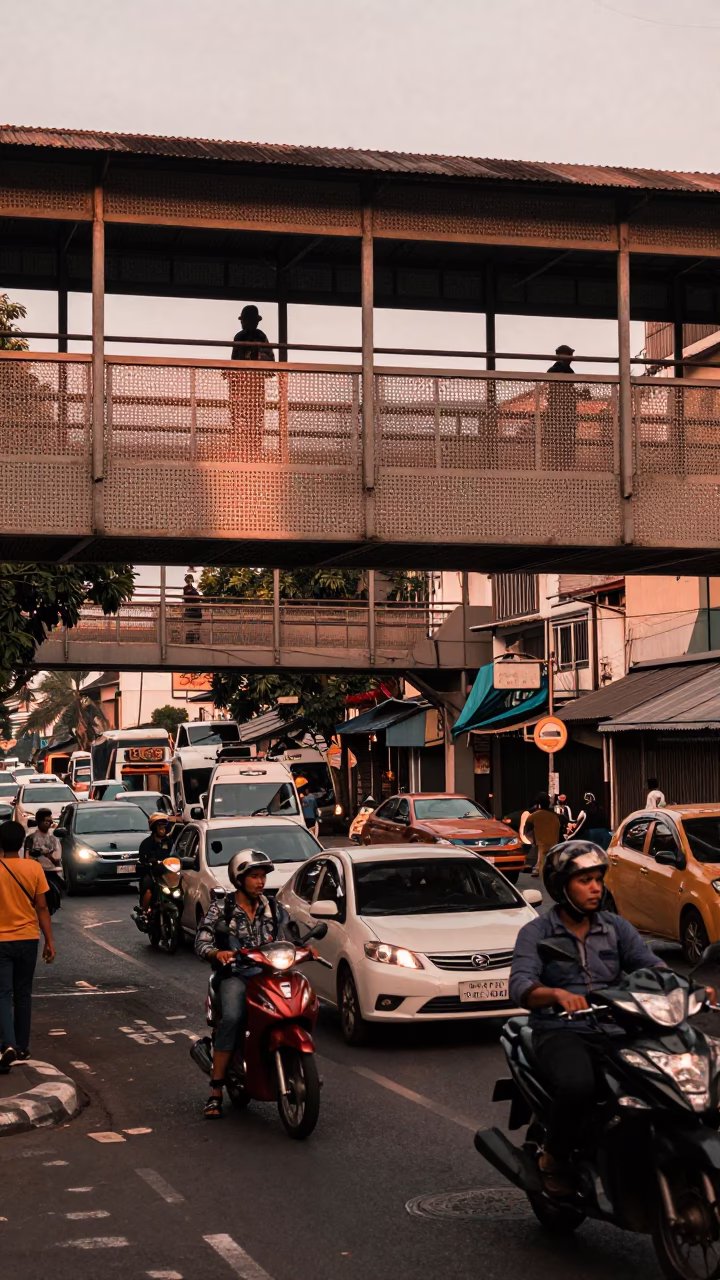 Busy Surabaya Street Scene with Perforated Metal Overpass and Copper Dusk Light in in Surabaya, Indonesia