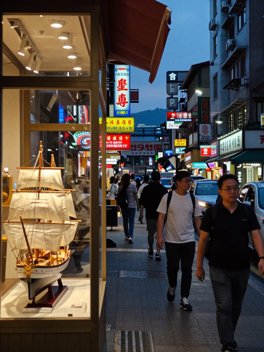 Busy Taipei Night Street Scene with Neon Signs and Steamship Model Display in Window in in Taipei, Taiwan