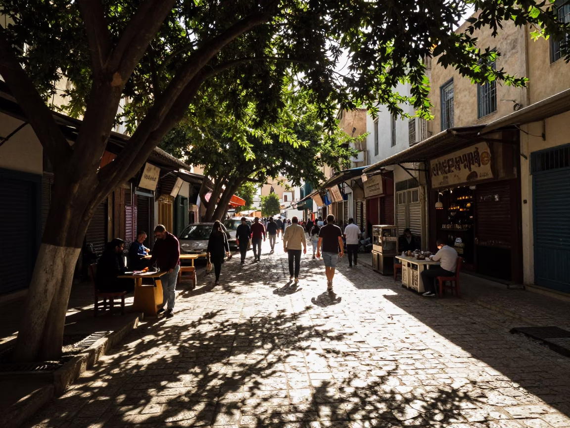 Busy Tunis Street Scene Late Morning with Leaf Shadows and Spinning Top in in Tunis, Tunisia