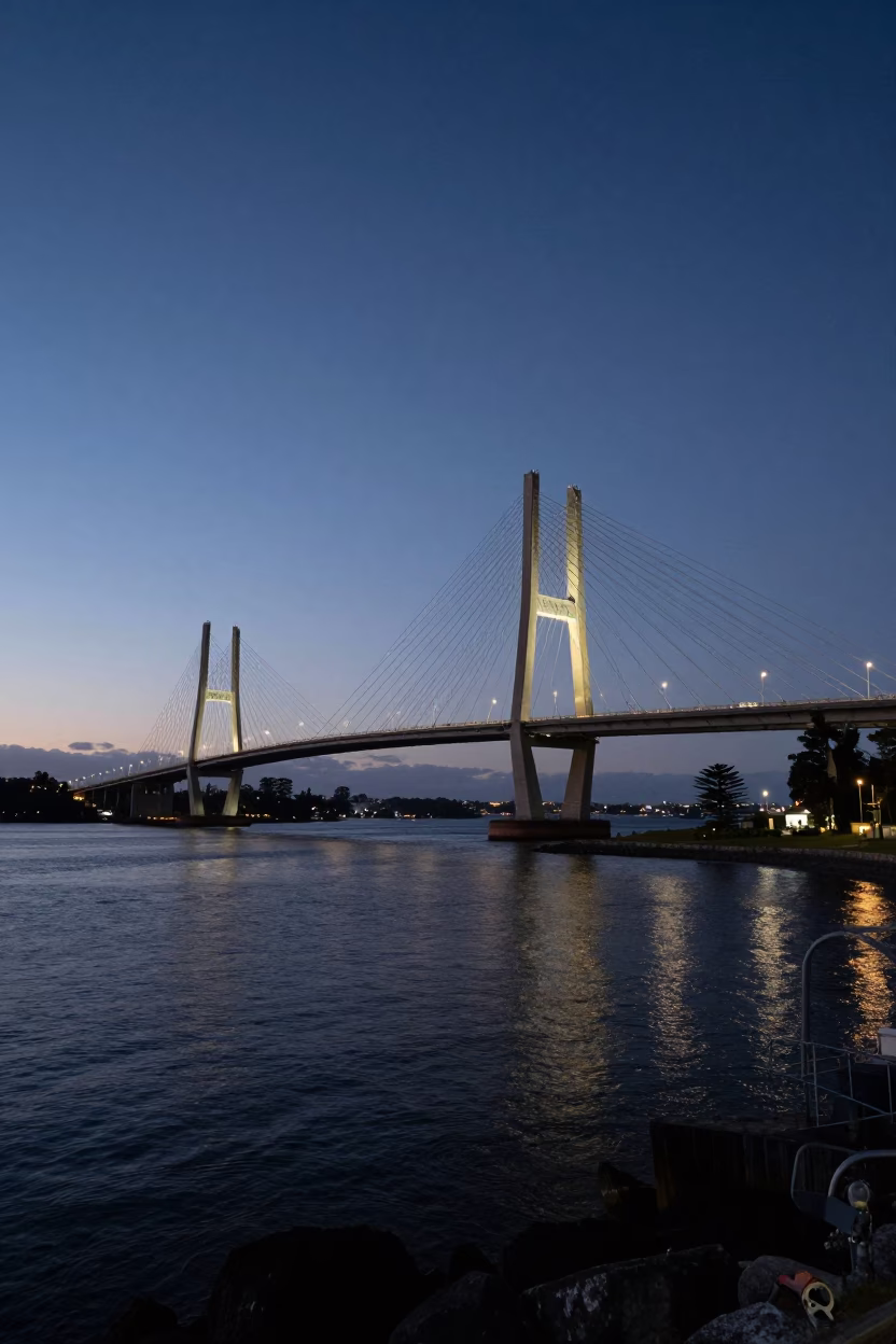 Cable-stayed bridge illuminated against dark harbor predawn Perth Western Australia street scene in in Perth, Western Australia, Australia