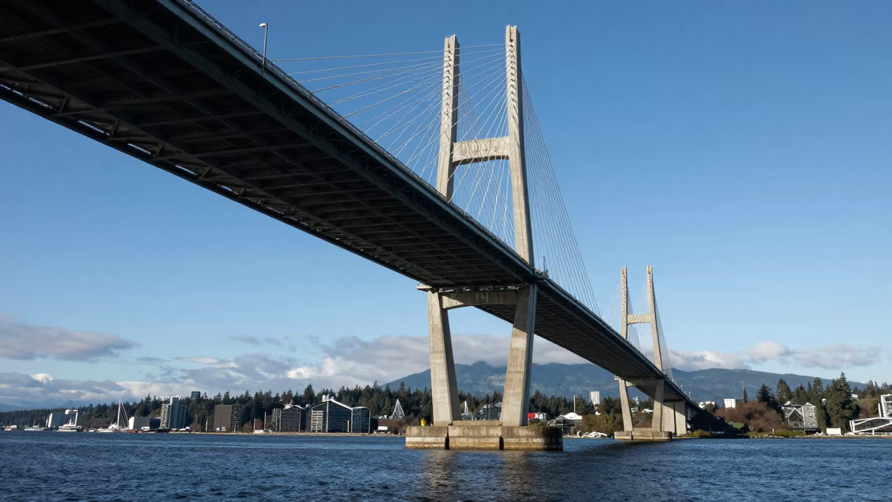 Cable-stayed Bridge Illuminated Dark Harbor Vancouver in under a viaduct of steel and concrete in Vancouver