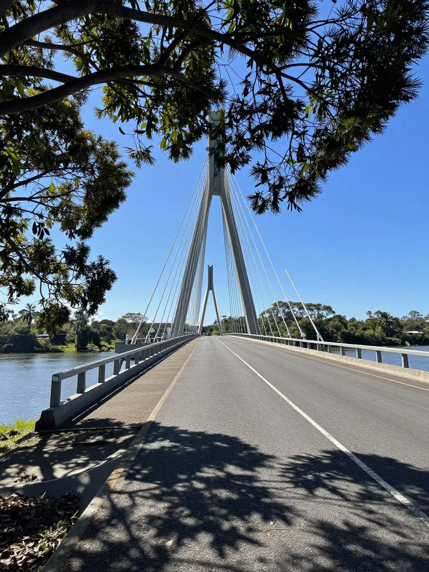 Cable Stayed Bridge Pier Dappled Light Harbor in beside a bridge pier above moving water in Queensland