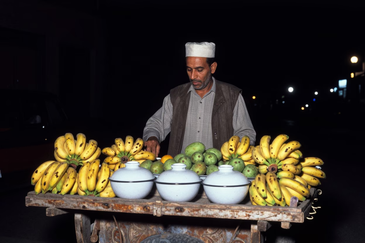 Cairo Street Night Scene with Fruit Vendor and Enamel Bowls Under Deep Sky in in Cairo, Egypt