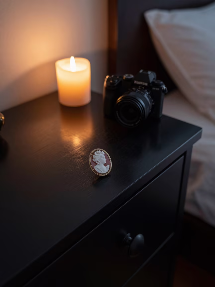 Cameo Pin on Lacquered Dresser in Candlelight in on a bedside table in Cúcuta