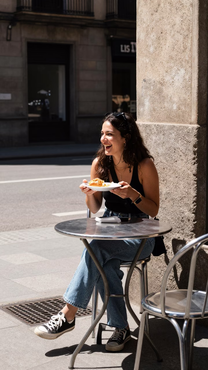Candid Barcelona Street Scene with Sunlight on Drain and Plate at Outdoor Cafe in in Barcelona, Spain