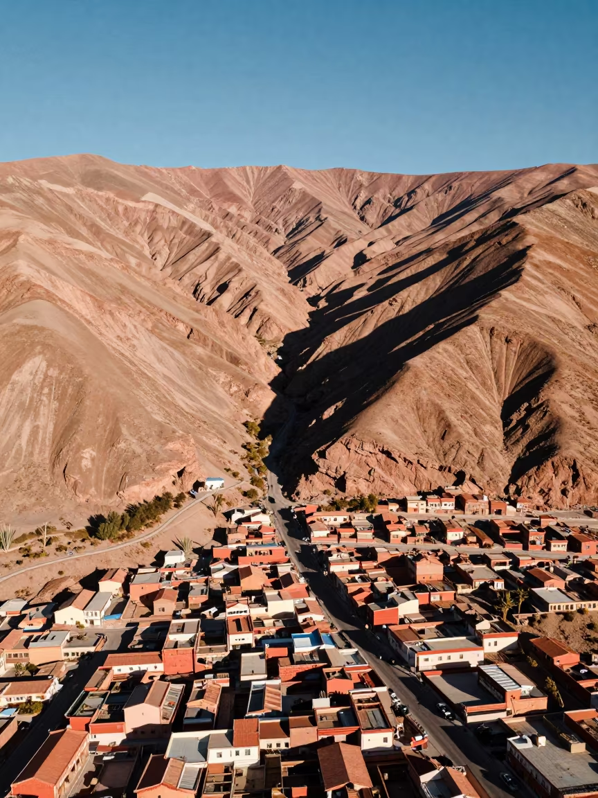 Canyon Shadow Slices Ochre Plateau Chile in high above patterned rooftops in Chile