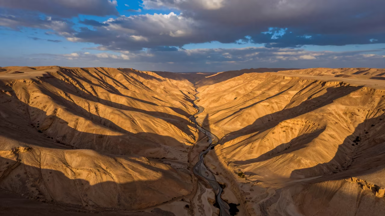 Canyon Shadow Slicing Ochre Libya Plateau in far above terraced hillsides in Libya