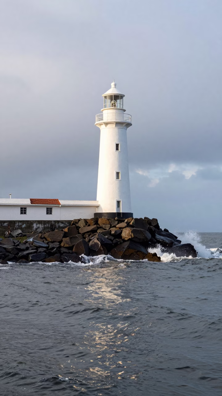 Carupano Lighthouse on Rocky Stack Reflected in beside a canal-front facade in Carúpano