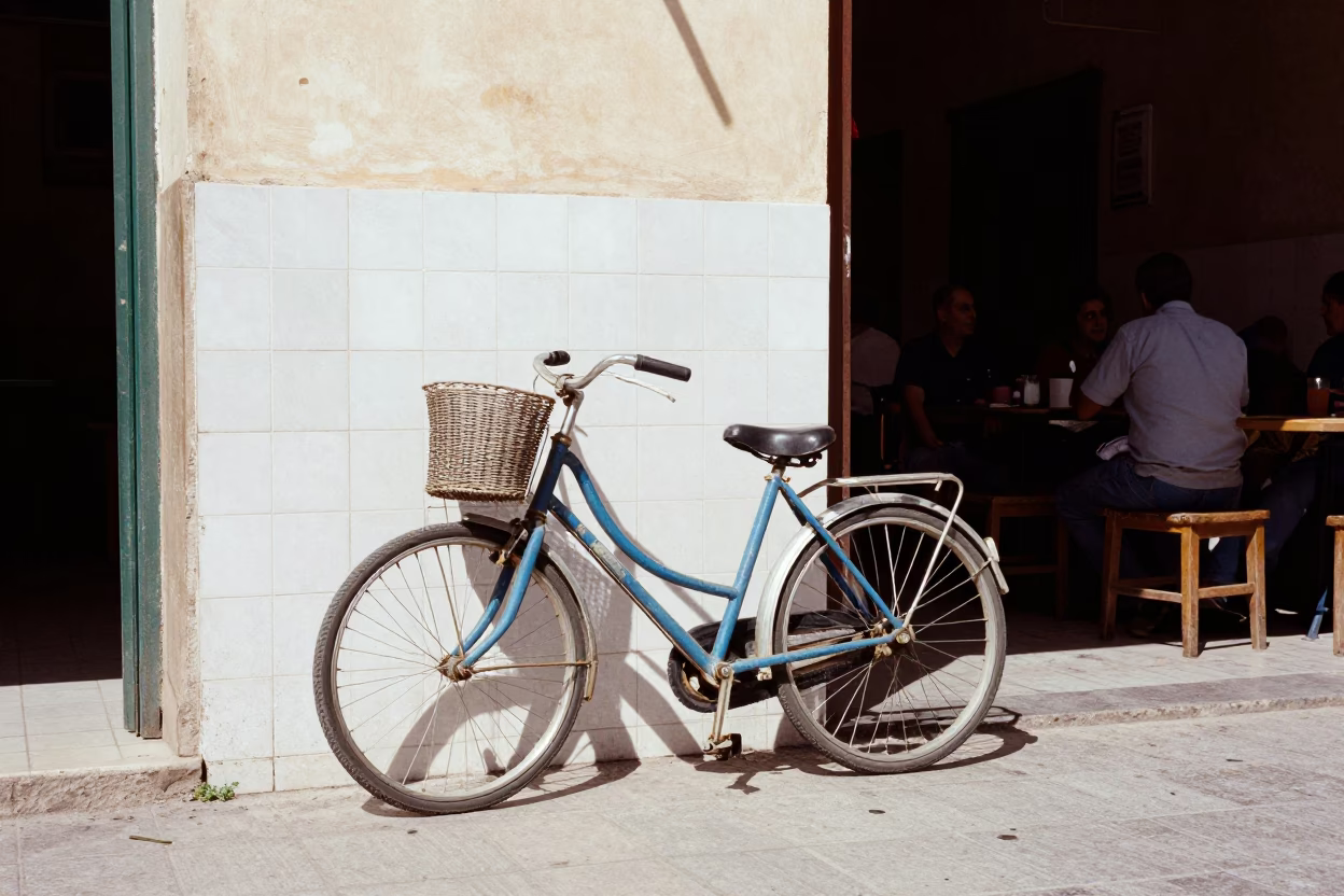 Casablanca street scene with bicycle leaning against cafe under noon glare in in Casablanca, Morocco