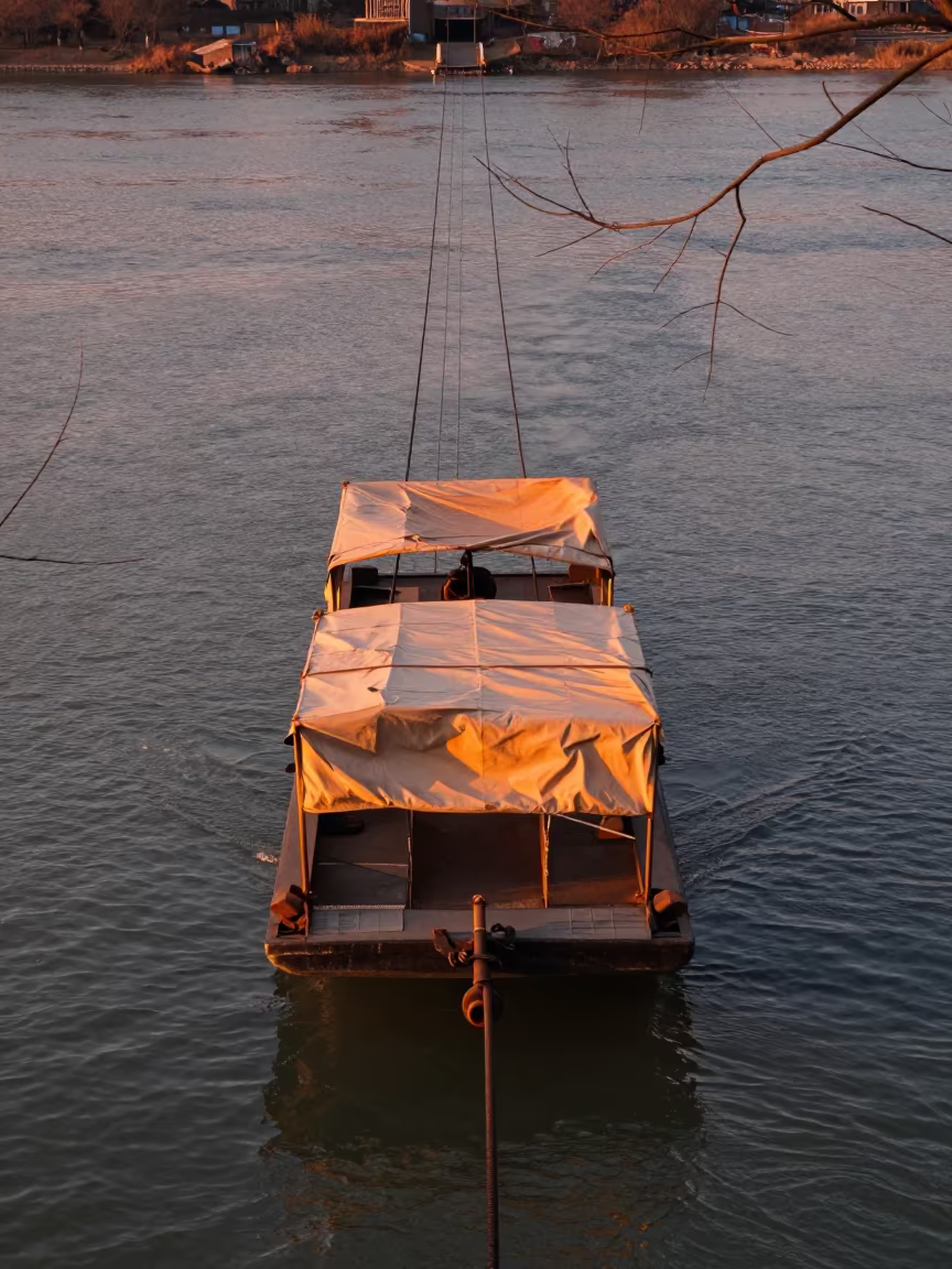 Chain Ferry Crossing River in Evening Light in along a switchback approach in Jiangxi