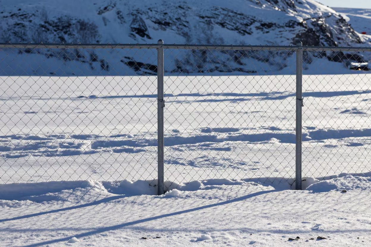 Chain Link Fence Shadow on Snow Floor in in Norway