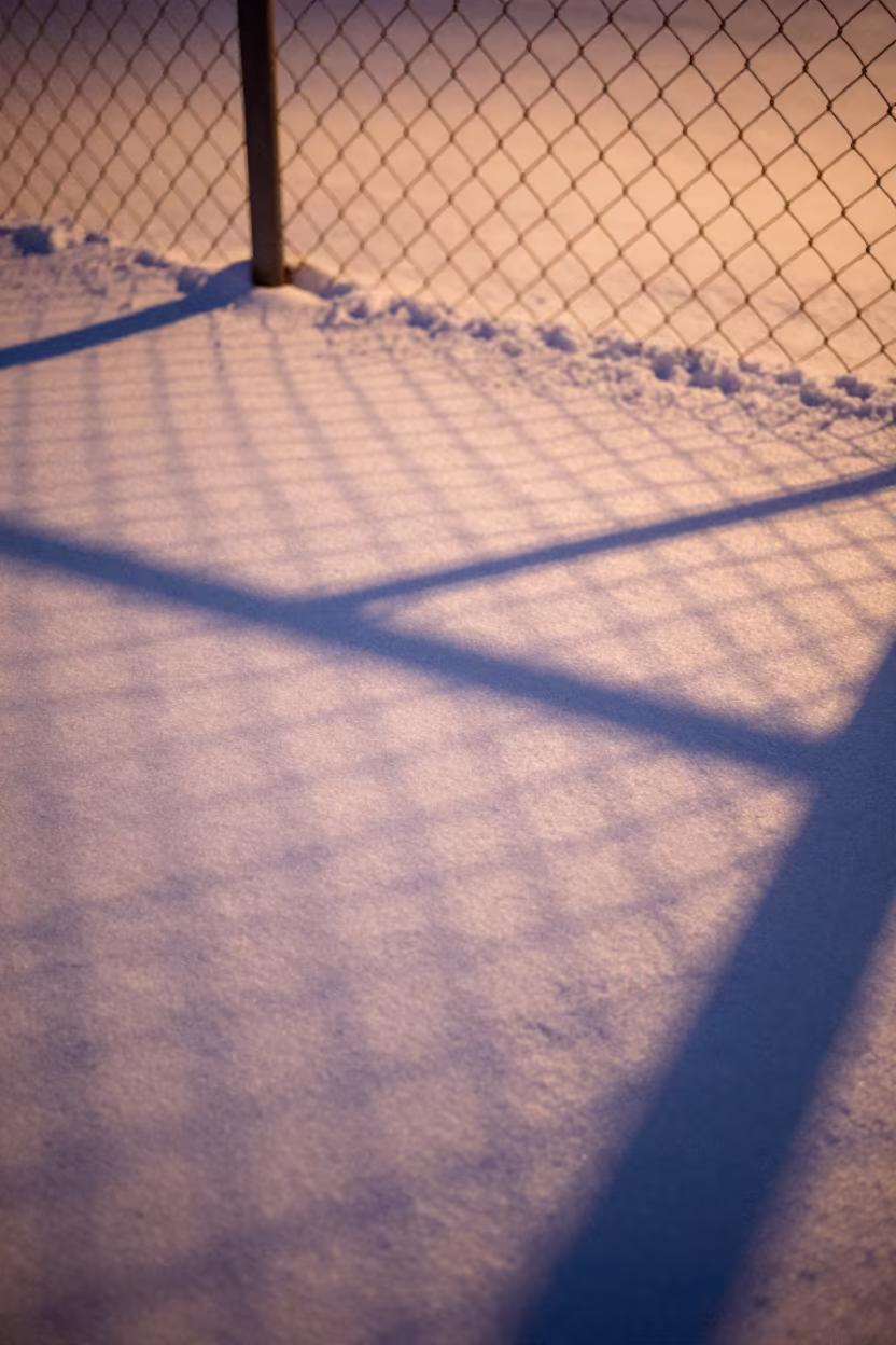 Chain Link Fence Shadows on Fresh Snow in near Stockholm