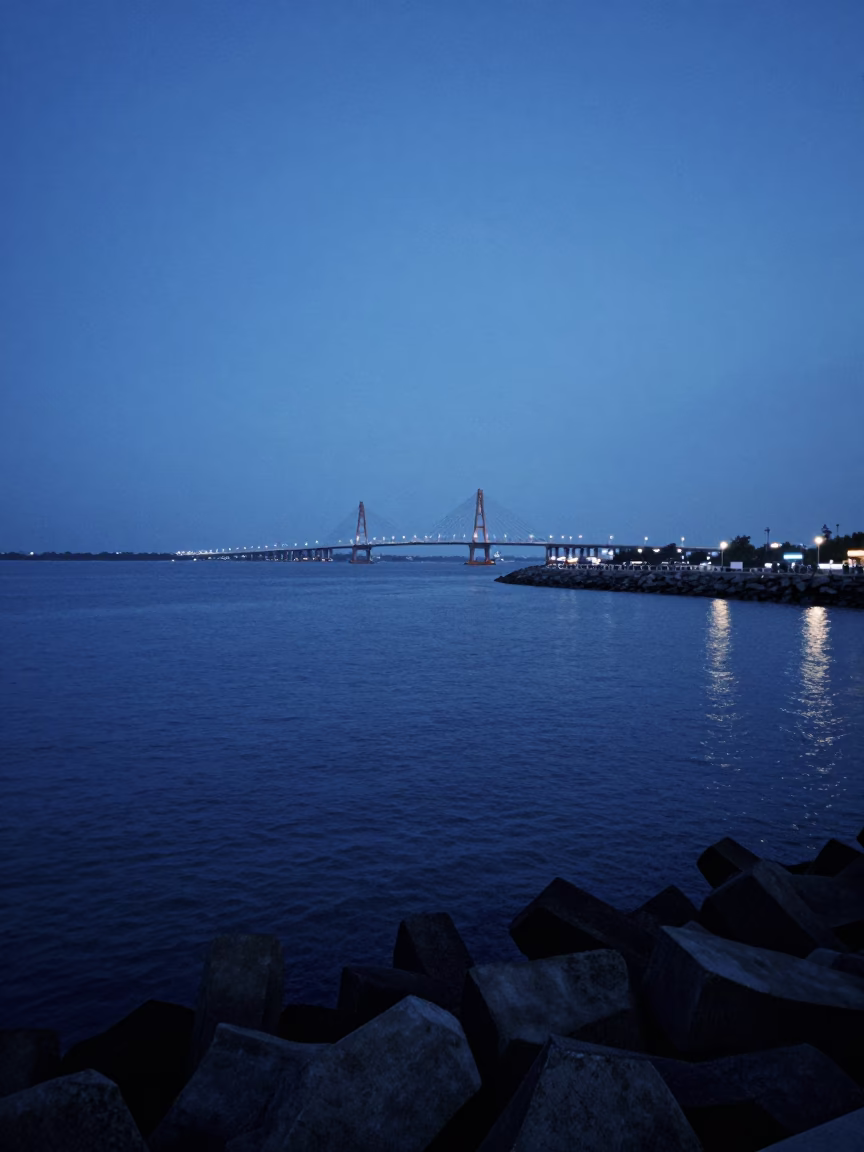 Chennai India Evening Harbor Breakwater with Distant Bridge Construction Sparks in in Chennai, India