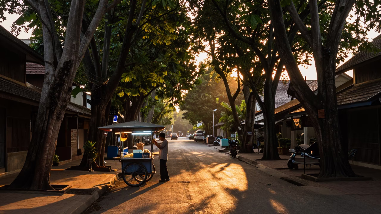 Chiang Mai street scene at sunset with food vendor and rainy puddles in in Chiang Mai, Thailand