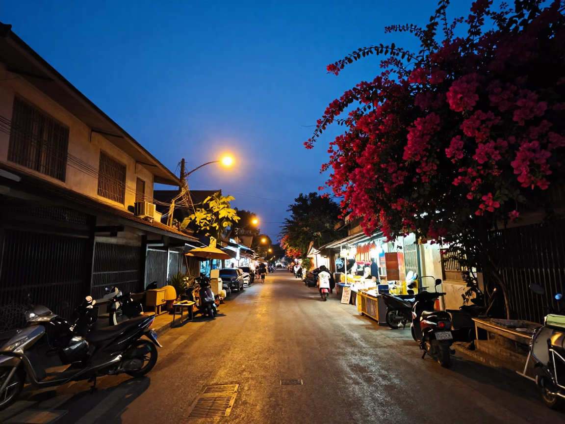 Chiang Mai Thailand twilight street scene with bougainvillea and local market activity in in Chiang Mai, Thailand