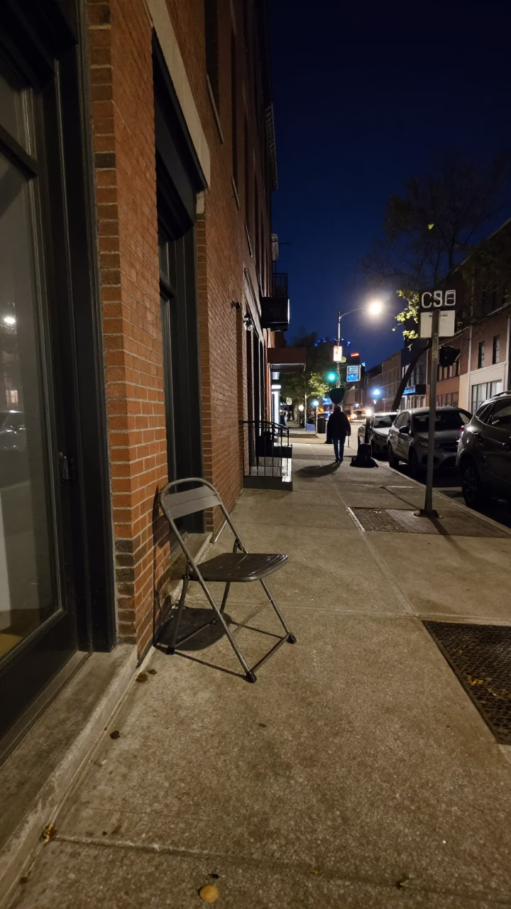 Chicago Night Street Scene with Folding Chair and Water Bottle Under Deep Sky in in Chicago, Illinois, United States