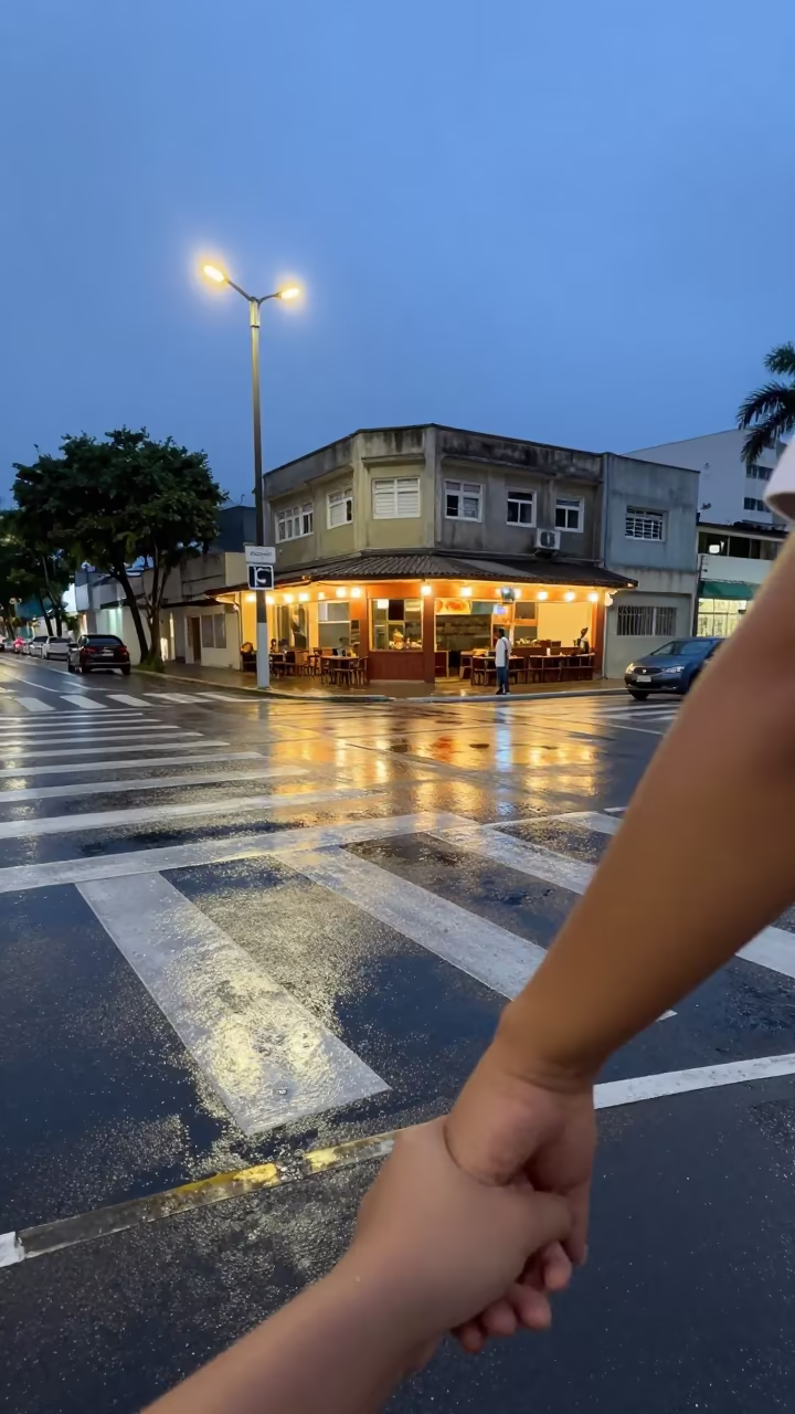 Child holding parent hand at Fortaleza crosswalk in outside a corner cafe in Fortaleza