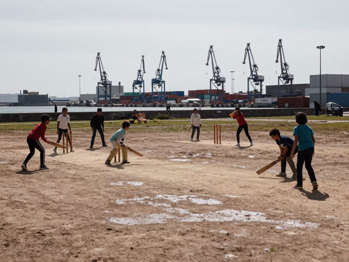 Children Playing Cricket on Harbor Quay in Late Spring in at a harbor quay near Santander