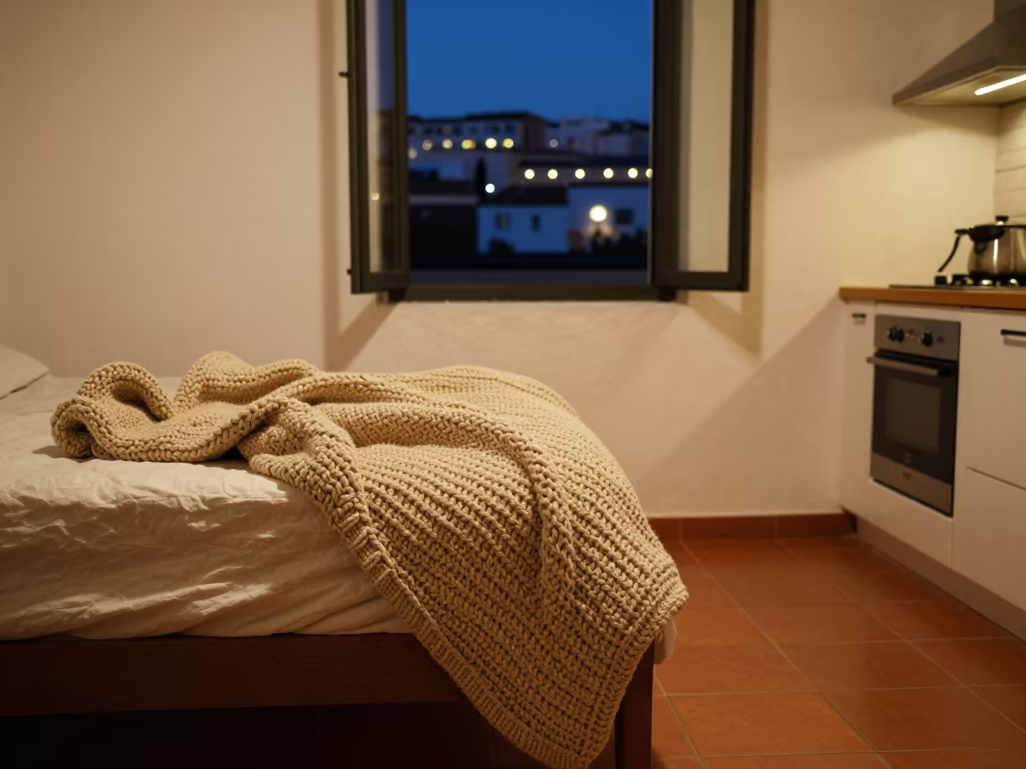 Chunky Knit Blanket on Unmade Bed in Malaga Kitchen in in a cozy kitchen in Malaga