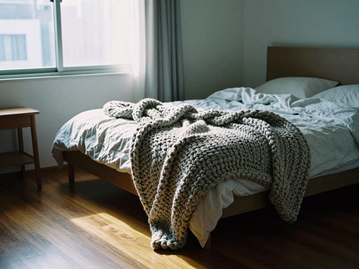 Chunky Knit Blanket on Unmade Bed in Sunlit Room in in a sunlit living room near Quezon City