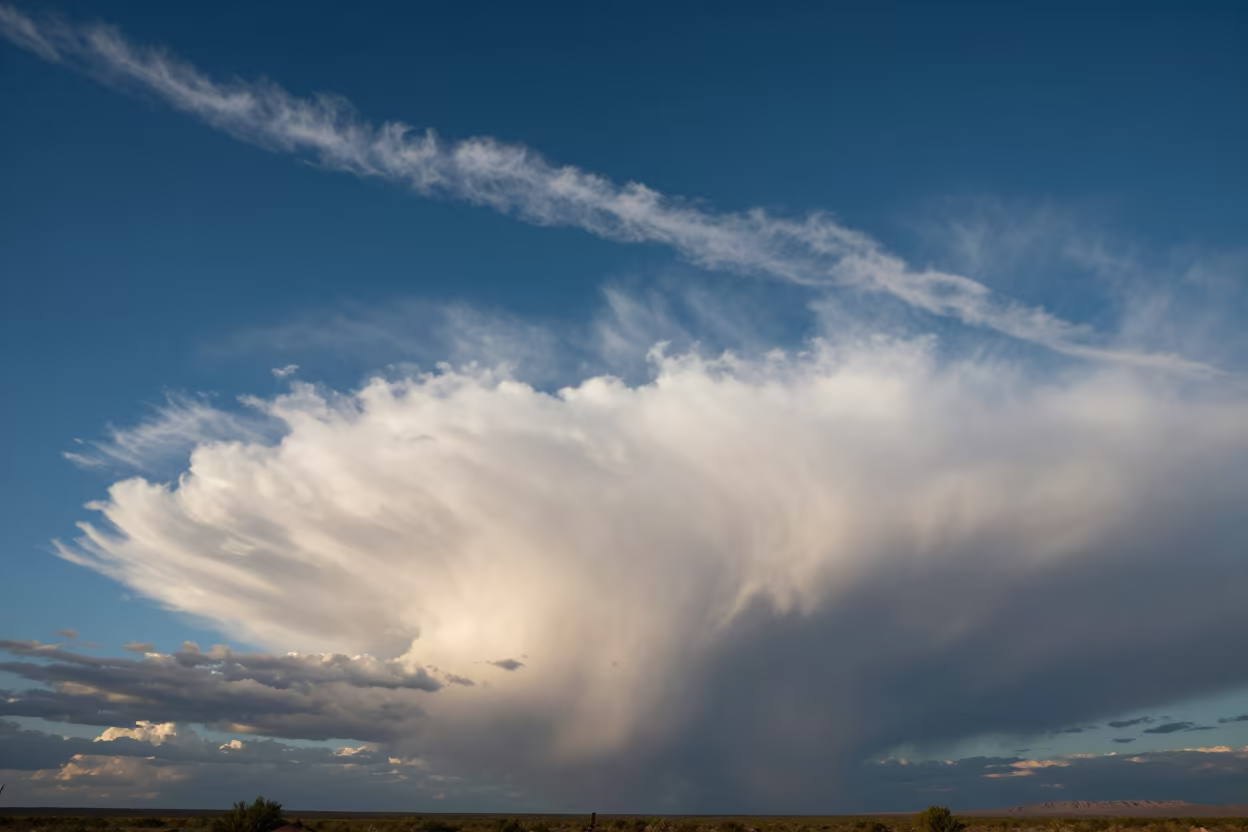 Cirrus Streak Over Arizona Thunderheads in over a horizon of stacked thunderheads in Arizona