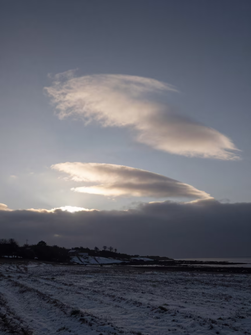 Cirrus Uncinus Clouds Over Brittany Winter Dawn in beneath fast-moving cloud bands in Brittany