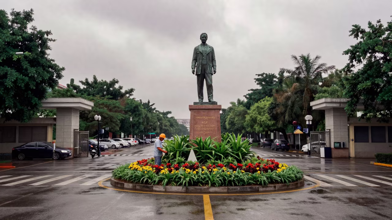 City Worker Trims Flowers at Haikou School Gate in at a crosswalk by a school gate in Haikou