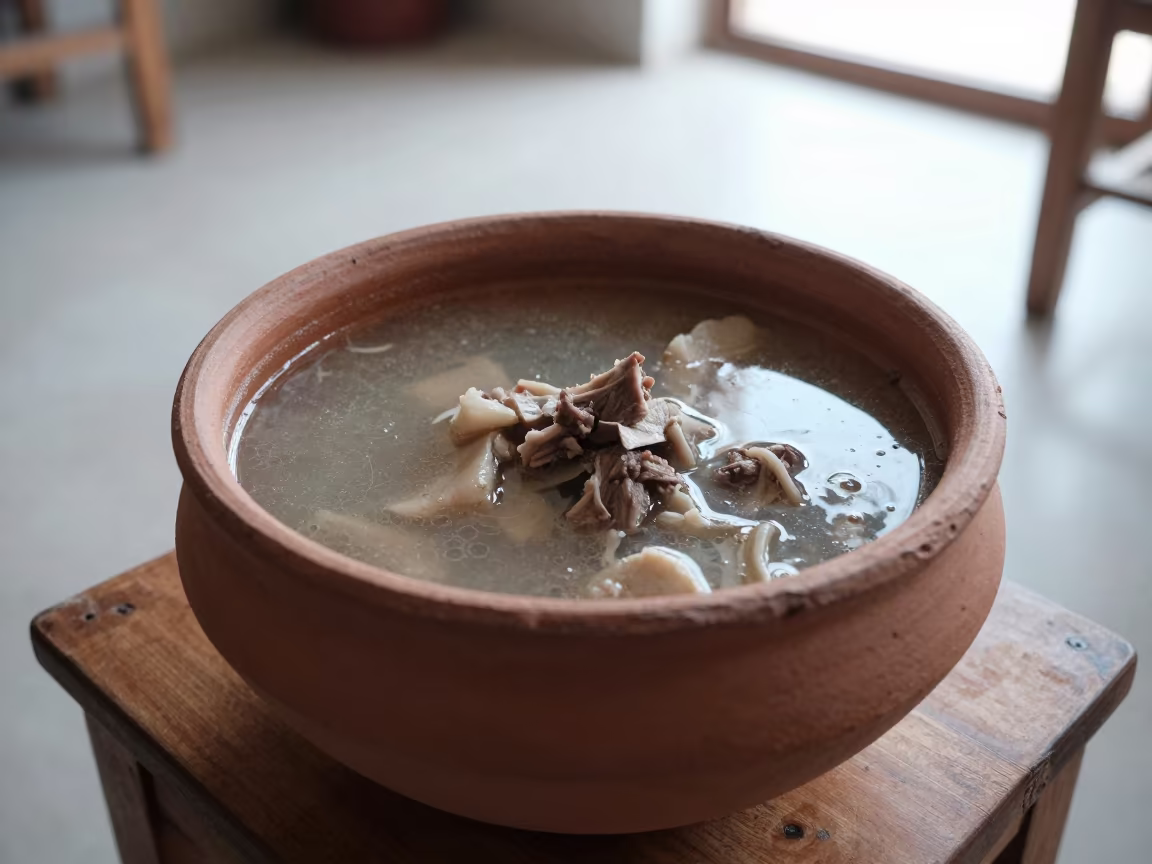 Clay Pot of Azerbaijani Lamb Piti Soup on Table in on a small dining table by a window in Pokhara