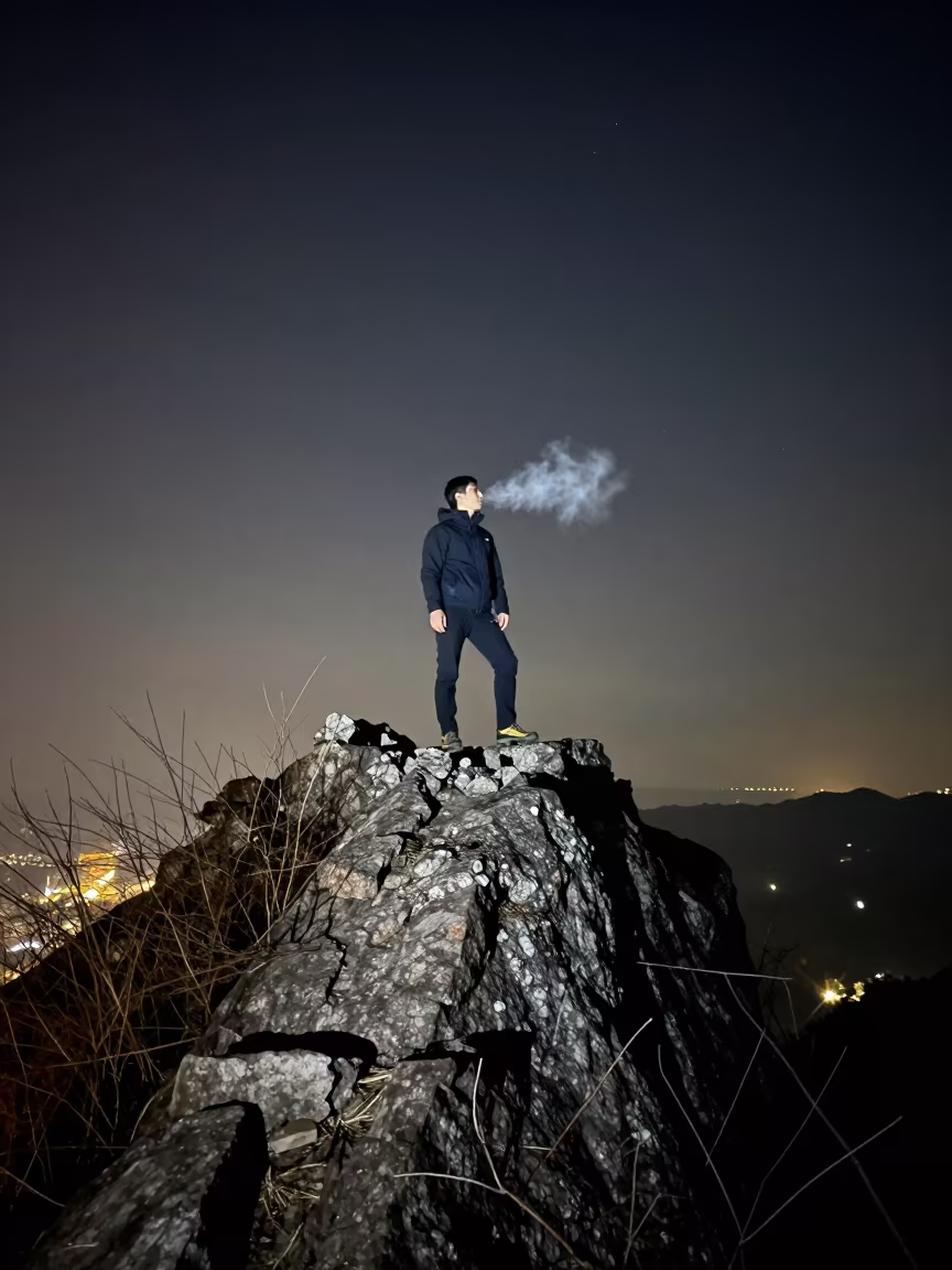 Climber Topping Granite Spire Under Starlight in on a mountain path near Chongqing