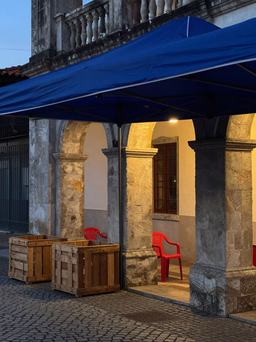 Closing Market Canopy Under Tungsten Dawn Light in under a market canopy in Florianopolis