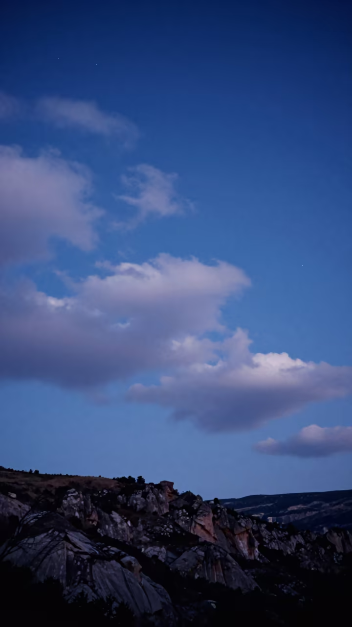 Cloud Streaks Over Nevsehir in Cobalt Twilight in beneath thin cloud gaps and stars near Nevşehir