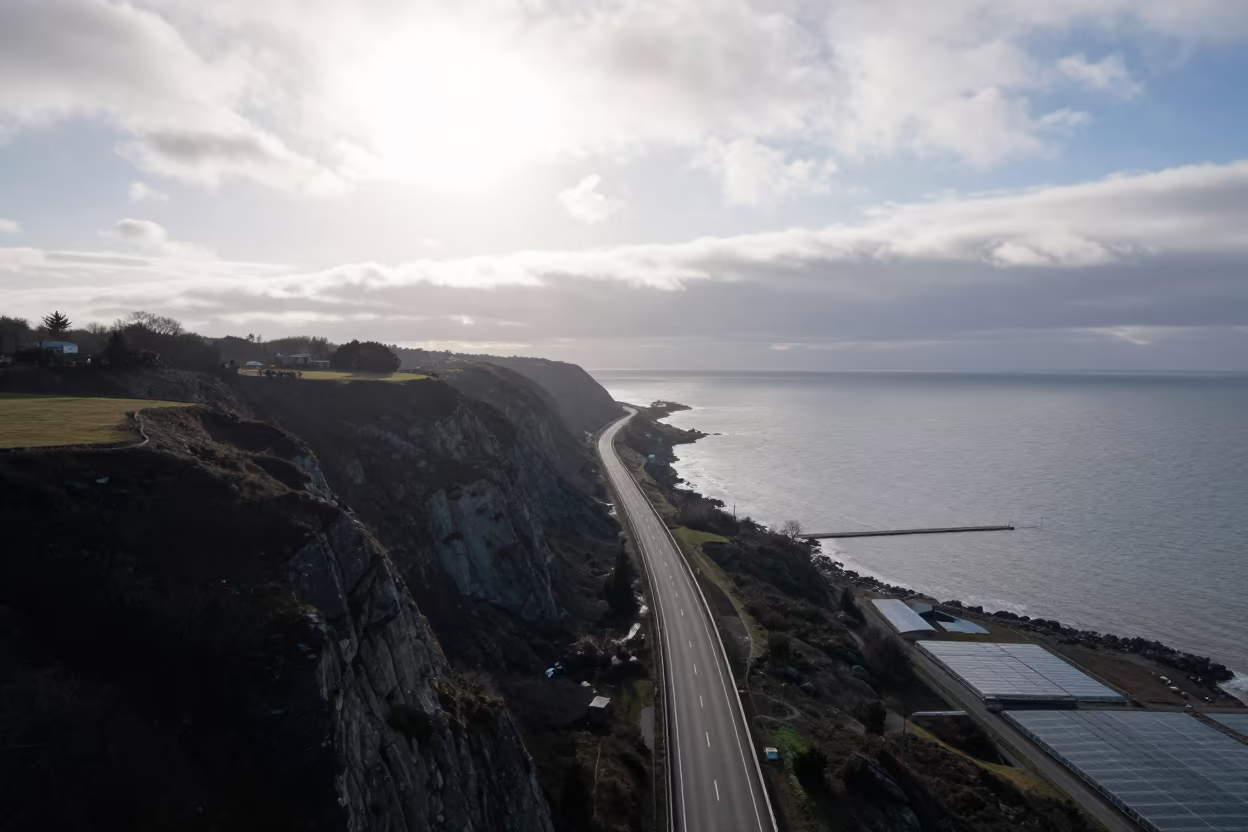 Coastal Highway Cliff Edge Aerial View in high over greenhouse grids near Almaty