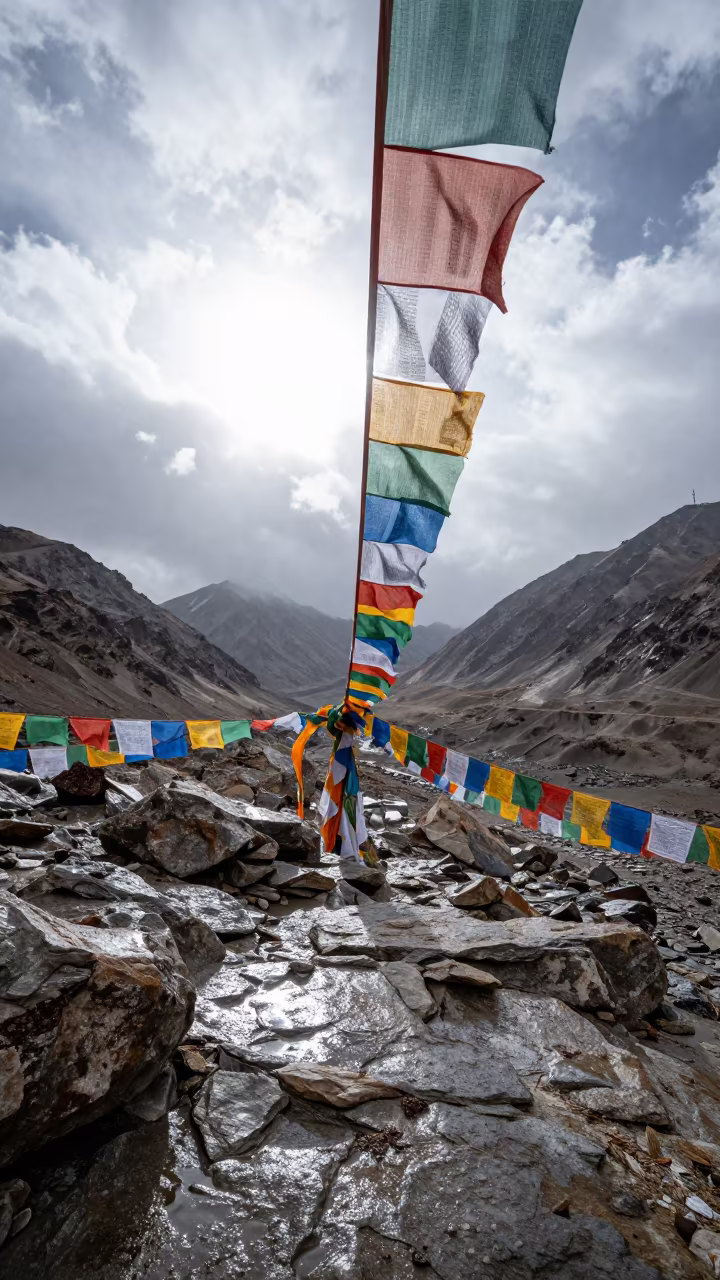 Colorful Prayer Flags on Rocky Mountain Pass Leh in at a rocky saddle overlooking a mountain valley near Leh