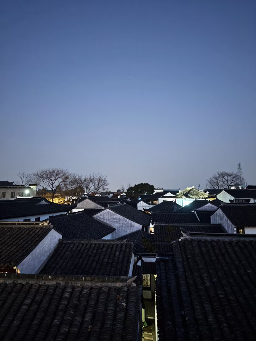 Comet Haze Over Suzhou Rooftops at Twilight in from a moonlit breakwater near Suzhou