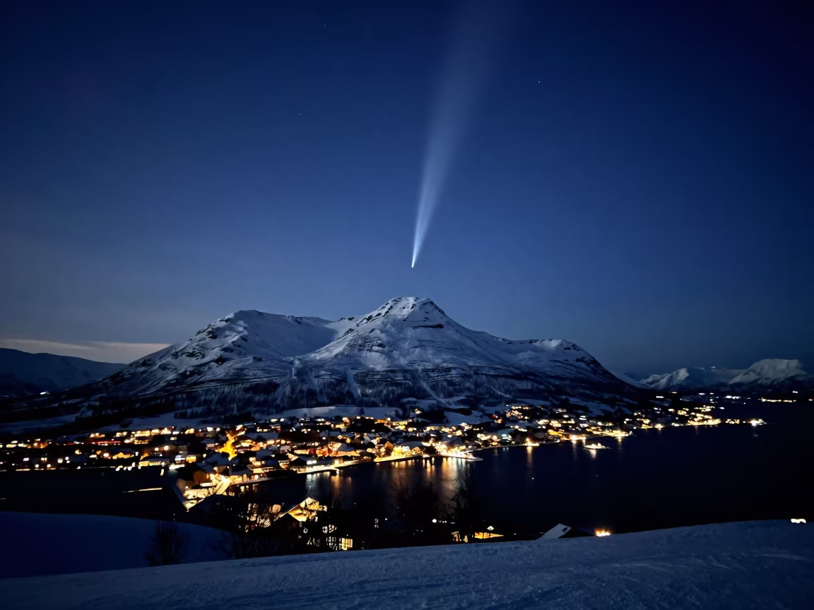 Comet Tail Above Snow Peak Sweden Midnight Sun in beneath a moon-washed horizon in Sweden