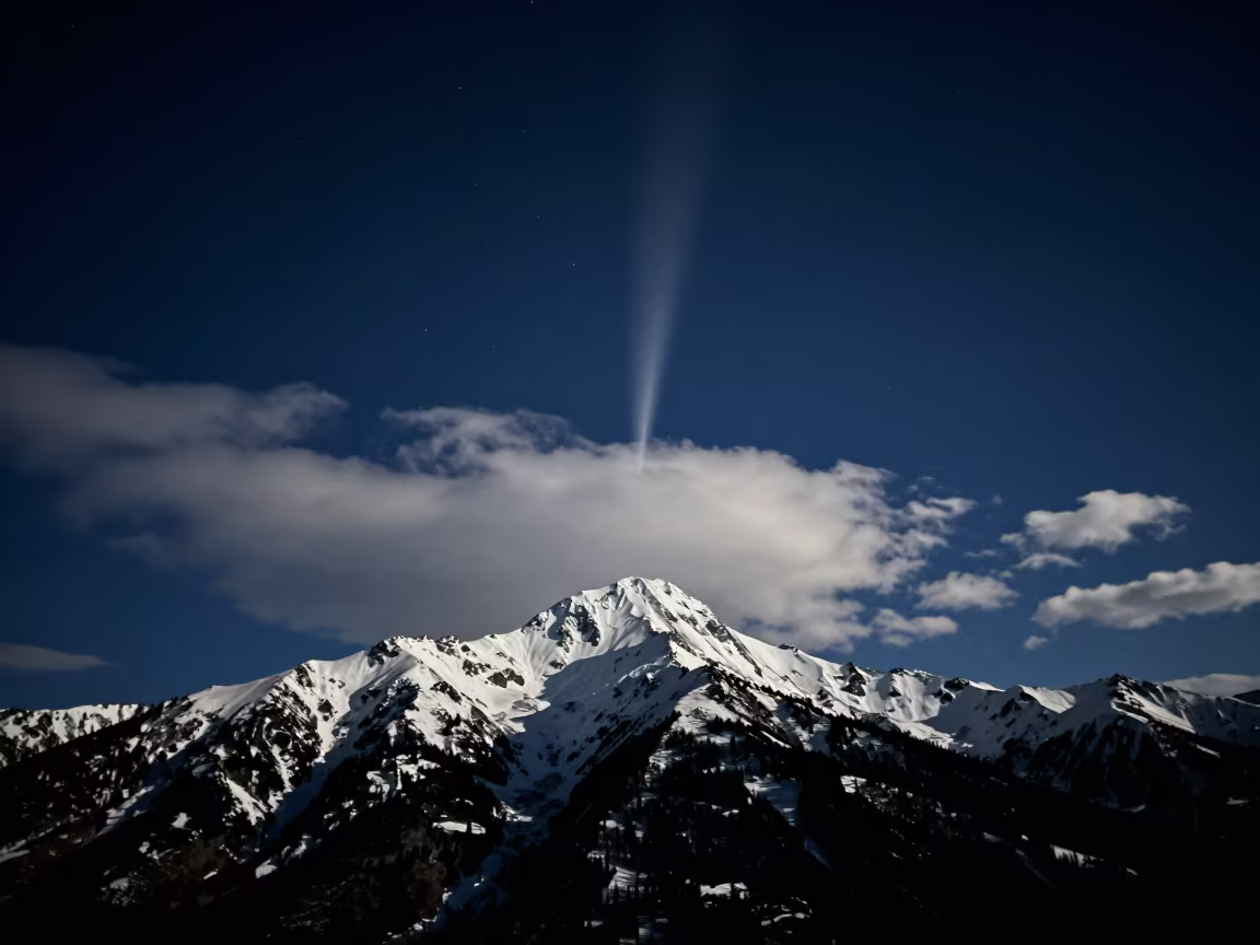 Comet Tail Over Snow Peak at Midnight in under a band of cold starlight near Strathcona, Vancouver