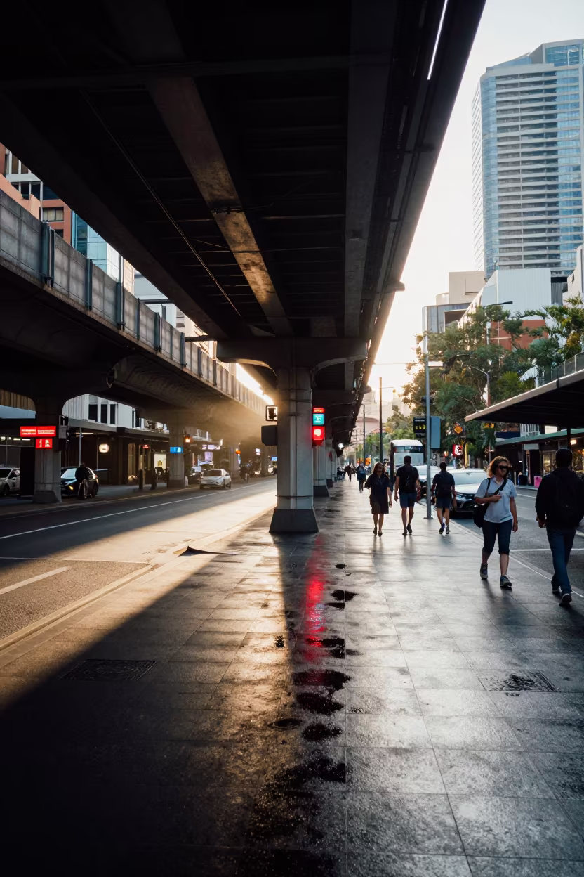 Commuter Reflections in Neon Puddle Under Melbourne Train in under an elevated train line in Melbourne