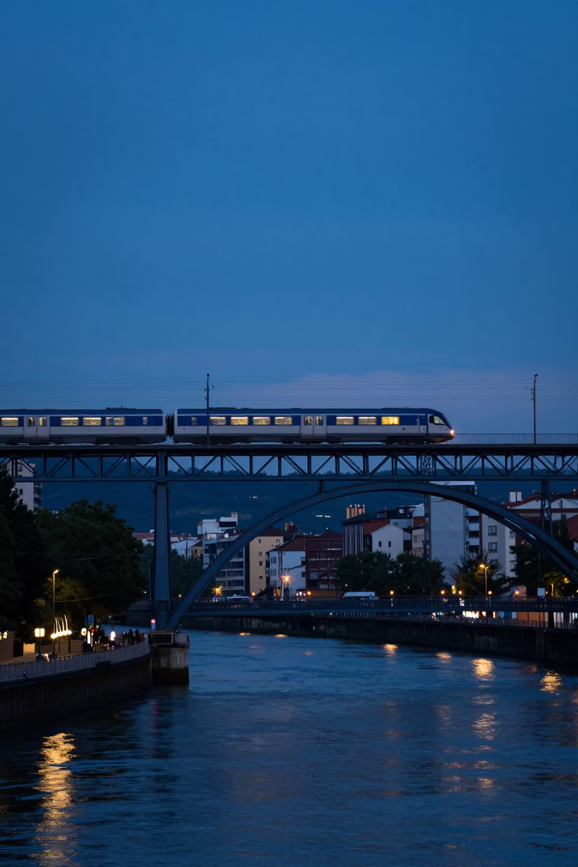 Commuter train crossing bridge at blue hour in Bilbao Spain evening light in in Bilbao, Spain