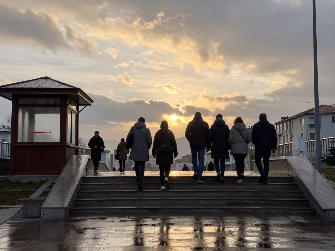 Commuters Climbing Wet Stairs from Underpass in by a rain-darkened kiosk in Daşoguz