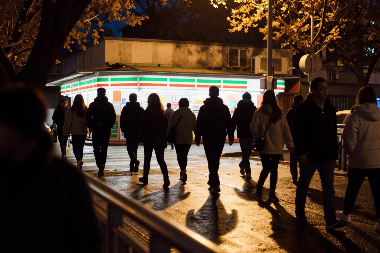 Commuters Silhouetted in Evening Overpass Dadu in outside a fluorescent convenience store in Dadu