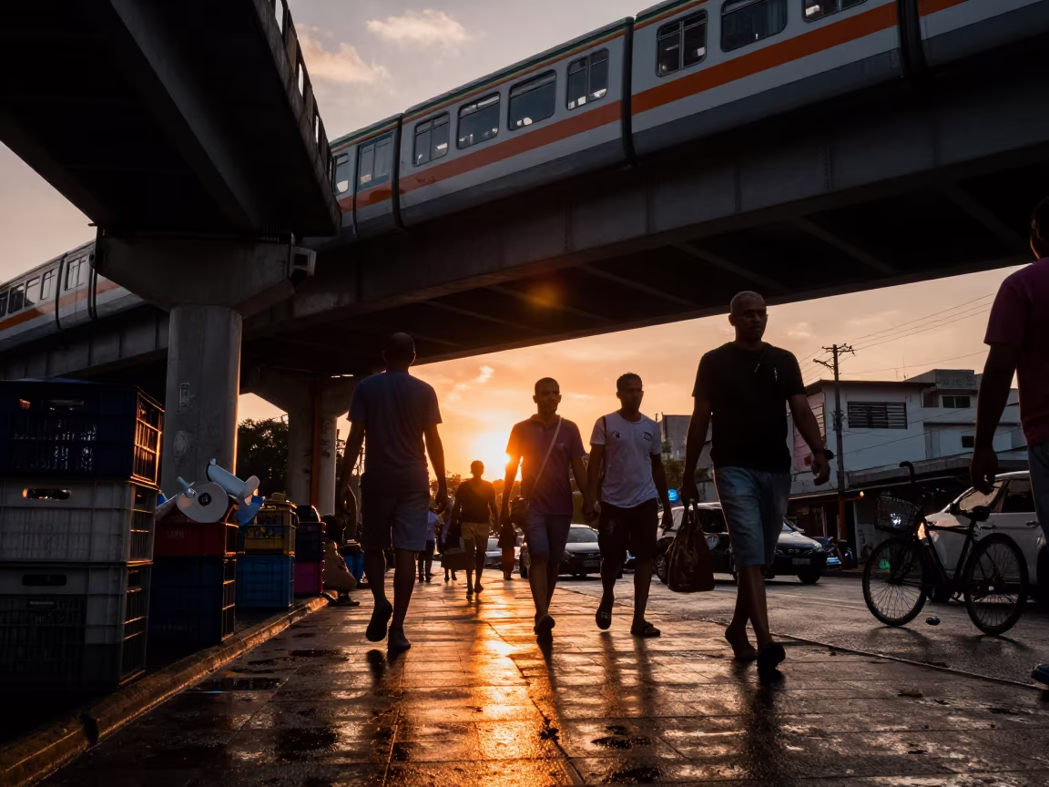 Commuters Silhouetted Under Benguela Train Line in under an elevated train line in Benguela