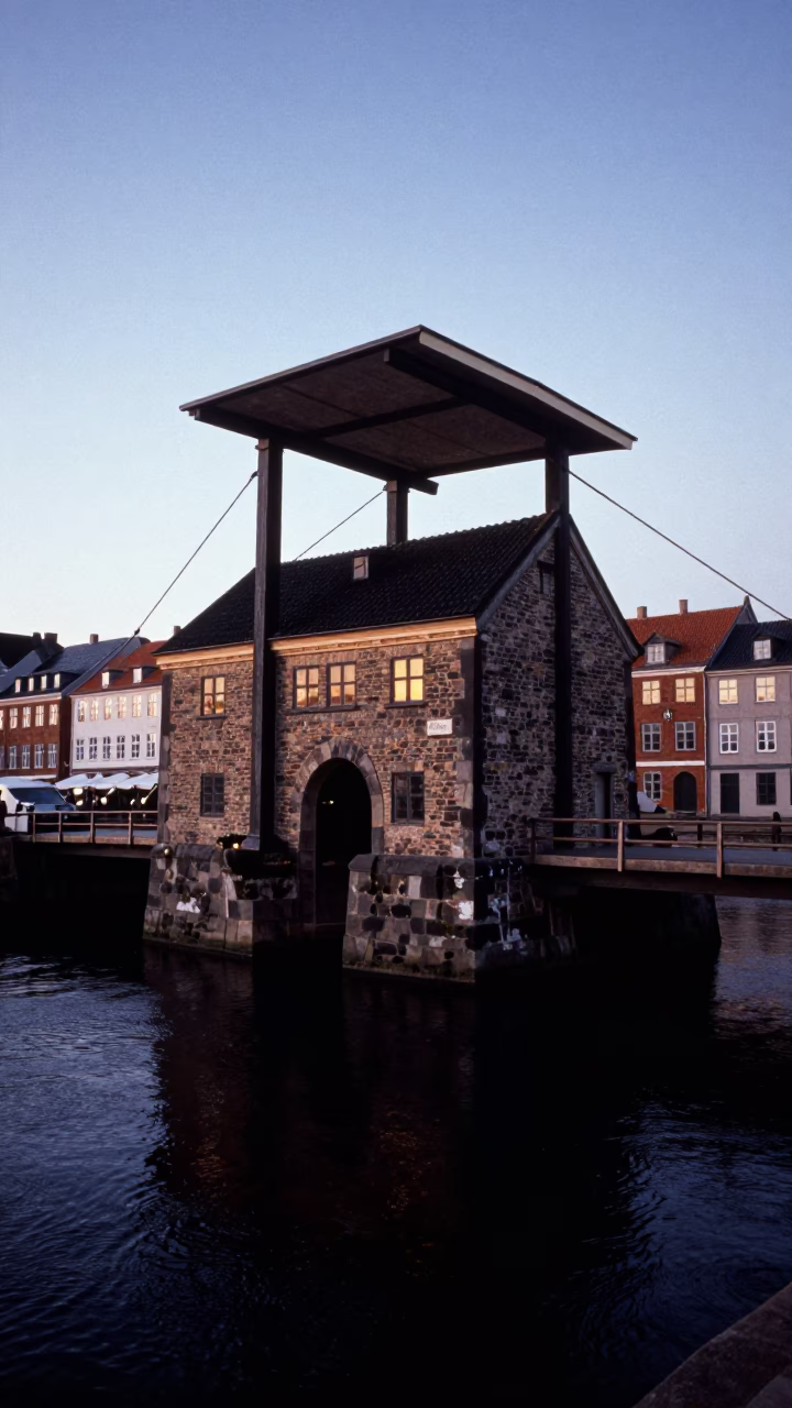 Copenhagen Drawbridge Counterweight House Above Black Tidal Channel Before Dawn in in Copenhagen, Denmark