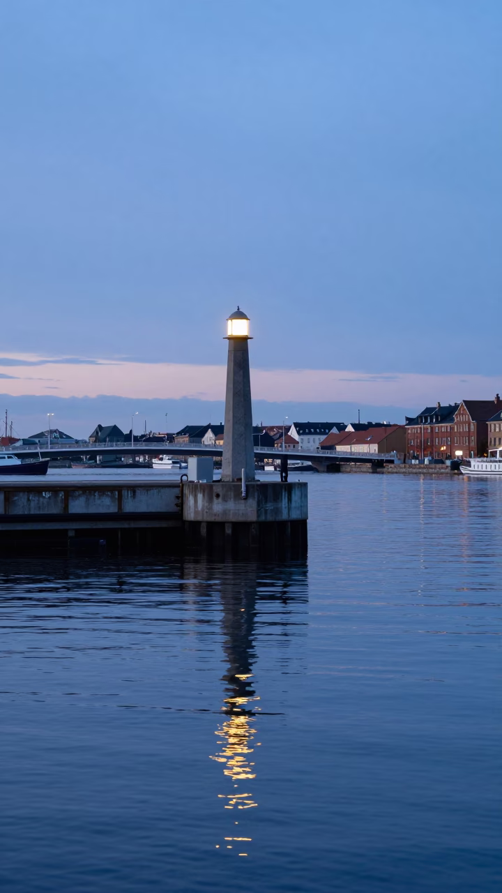 Copenhagen Harbor Dawn Light Reflecting on Bridge Pier and Still Water in in Copenhagen, Denmark