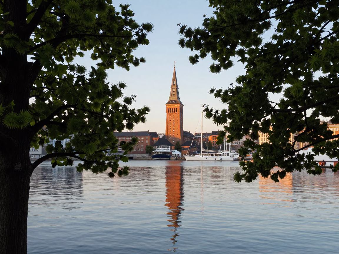 Copenhagen Harbor Early Morning Light Reflecting on Water Tower and Chestnut Trees in in Copenhagen, Denmark